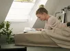 Man werkt aan bureau onder Velux vouwgordijn FH-B